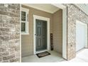 View of the front door and porch area, accented by brickwork and neutral siding at 2039 Wildflower Nw Way, Conyers, GA 30012