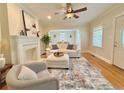 Open-concept living room with hardwood floors, fireplace, and stylish decor at 2437 N Decatur Rd, Decatur, GA 30033