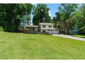 Charming home featuring a lush front lawn and a two-car attached garage at 919 Rock Oak Ln, Lawrenceville, GA 30046