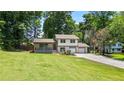 Charming home featuring a lush front lawn and a two-car attached garage at 919 Rock Oak Ln, Lawrenceville, GA 30046