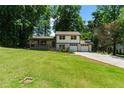 Charming home featuring a lush front lawn and a two-car attached garage at 919 Rock Oak Ln, Lawrenceville, GA 30046