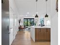 Modern entryway with view of open living area, sleek kitchen and tree views through sliding doors at 112 Rogers Street Northeast Ne St # 410, Atlanta, GA 30317