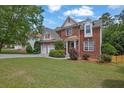 Beautiful brick home with manicured lawn, two-car garage, and lovely landscaping at 2988 Belfaire Lake Dr, Dacula, GA 30019