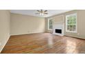 Spacious living room boasts hardwood floors, fireplace, and ample natural light at 2988 Belfaire Lake Dr, Dacula, GA 30019