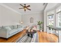 Cozy living room with hardwood floors, large windows, and a stylish rug and furniture at 3519 Preserve Se Dr, Atlanta, GA 30339