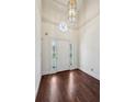 Bright foyer featuring hardwood floors, a decorative light fixture, and a stylish front door at 51 Ivy Chase Ne, Atlanta, GA 30342