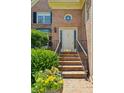 Elegant brick home entrance with beautiful landscaping and stairs leading to the front door at 51 Ivy Chase Ne, Atlanta, GA 30342