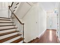 Traditional staircase with wood steps and wrought iron railing, leading to the upper level at 51 Ivy Chase Ne, Atlanta, GA 30342