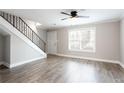 Inviting living room with staircase, large window providing natural light, and wood-look flooring at 7 Villa Se Ct, Smyrna, GA 30080
