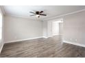 Spacious living room featuring modern gray floors, white trim, a ceiling fan, and neutral paint at 7 Villa Se Ct, Smyrna, GA 30080