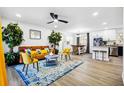 Open-concept living room with view of kitchen, modern furniture, and stylish accents at 7994 Devonshire Dr, Jonesboro, GA 30238