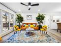 Bright and open living room featuring modern decor, plants, and hardwood floors at 7994 Devonshire Dr, Jonesboro, GA 30238