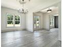 Dining room filled with natural light showcasing floors and elegant chandelier at 110 Northwood Creek Way, Oxford, GA 30054