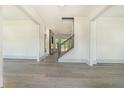 Light filled entryway with light gray floors and staircase to upper level at 110 Northwood Creek Way, Oxford, GA 30054