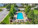 A clear aerial shot showcases a community pool surrounded by lounge chairs and greenery in a neighborhood at 200 Cherokee Reserve Cir, Canton, GA 30115