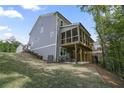 Back exterior showing the large back deck, screened-in porch, walk-out basement and large grassy yard at 421 Retreat Ln, Canton, GA 30114