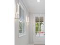 Bright foyer with a white front door, modern lighting, and view of the manicured neighborhood at 421 Retreat Ln, Canton, GA 30114