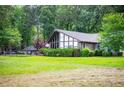 Stunning exterior elevation showcasing modern architecture, large windows, and meticulously maintained landscaping at 1050 Denton Rd, Douglasville, GA 30134