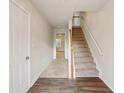 Bright entryway featuring hardwood floors, staircase with wooden banister, and access to other rooms at 2159 Meadow Peak Rd, Duluth, GA 30097