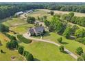 Aerial view highlighting the estate's sprawling property, barn facilities, and serene, tree-lined boundaries at 3480 Indian Shoals Rd, Dacula, GA 30019