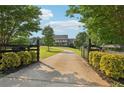 Long driveway leading to a charming home with meticulously maintained landscaping and inviting curb appeal at 3480 Indian Shoals Rd, Dacula, GA 30019