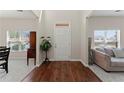 Bright entryway with hardwood floors, a tall ceiling, and an open view into the living room at 403 Sonja Ln, Loganville, GA 30052