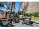 Relaxing outdoor space featuring a cozy fire pit and comfortable Adirondack chairs at 710 Elmwood Way, Roswell, GA 30075