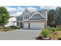 Charming two-story home with blue shutters and a well-manicured lawn and garden at 1017 Preserve Park Dr, Loganville, GA 30052