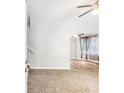 Living room with plush carpeting, ceiling fan, and archway leading to room with wood flooring at 127 Danielle Ct, Villa Rica, GA 30180