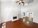 Spacious living room with a fireplace, hardwood floors, vaulted ceilings, and natural light at 1503 Colt Ridge Se Ln, Mableton, GA 30126