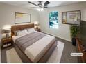 Cozy main bedroom featuring a ceiling fan and plush carpet, staged with a bed and side tables at 1503 Colt Ridge Se Ln, Mableton, GA 30126