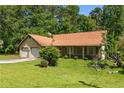Charming one-story home featuring an attached two-car garage, mature trees, and a well-maintained lawn at 2617 Laurel Woods Se Ln, Conyers, GA 30094