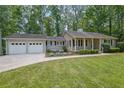 Well-maintained home with a 2-car garage, complemented by a lush green lawn and manicured landscaping at 4516 Creekwood Circle Nw, Kennesaw, GA 30152
