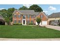 Charming two-story brick home featuring a manicured lawn, tasteful landscaping, and an attached two-car garage at 75 Hunters Ct, Dallas, GA 30157