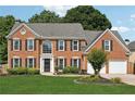 Traditional two-story brick home with a well-manicured lawn and a two car attached garage at 75 Hunters Ct, Dallas, GA 30157