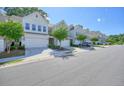 Neighborhood street featuring well-maintained townhomes and community landscaping at 128 Madison Bnd, Woodstock, GA 30188