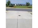 Spacious concrete driveway with a view of the community homes across the street at 3848 Hester St, Duluth, GA 30097