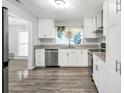 Modern kitchen with white cabinets, stainless steel appliances, and granite countertops at 4289 Post Rd, Winston, GA 30187