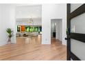 Bright, open foyer with hardwood floors, a view into the living area, and modern design elements at 5370 Greenleaf Sw Dr, Mableton, GA 30126