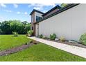Landscaped walkway leading to a modern home with a combination of siding and carefully placed decorative plants at 5370 Greenleaf Sw Dr, Mableton, GA 30126