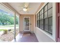 Cozy covered front porch with ceiling fan and a view of the landscaped front yard at 916 Forest Pointe Way, Jonesboro, GA 30238
