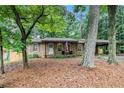Lovely brick home with a covered carport nestled amongst mature trees in a quiet neighborhood at 3431 Alcan Way, Tucker, GA 30084