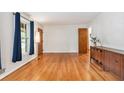 Bright living room with hardwood floors, vintage cabinet and accent lamp at 3431 Alcan Way, Tucker, GA 30084