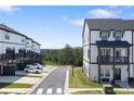 Townhouse complex featuring white siding with black trim and ample parking spaces at 823 Mackay Crk, Woodstock, GA 30188