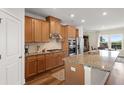 Bright kitchen with stainless steel appliances, granite countertops, and wood cabinetry at 823 Mackay Crk, Woodstock, GA 30188