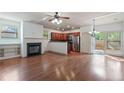 Open concept living area with a cozy fireplace, hardwood floors, and an adjacent modern kitchen at 1071 N Village Dr, Decatur, GA 30032