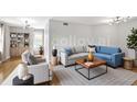 Bright living room featuring hardwood floors, neutral walls, and modern furnishings at 199 14Th Ne St # 402, Atlanta, GA 30309