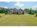Beautiful home with a well-kept lawn and a three-car garage with a basketball hoop at 265 Enfield Ln, Mcdonough, GA 30252