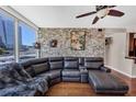 Inviting living room featuring a comfortable leather sectional, exposed brick wall, and stunning city views at 3338 Peachtree Ne Rd # 508, Atlanta, GA 30326