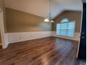 Bright dining room featuring new wood flooring, modern trim, and a window at 3878 Hannahberry Pl, Buford, GA 30519